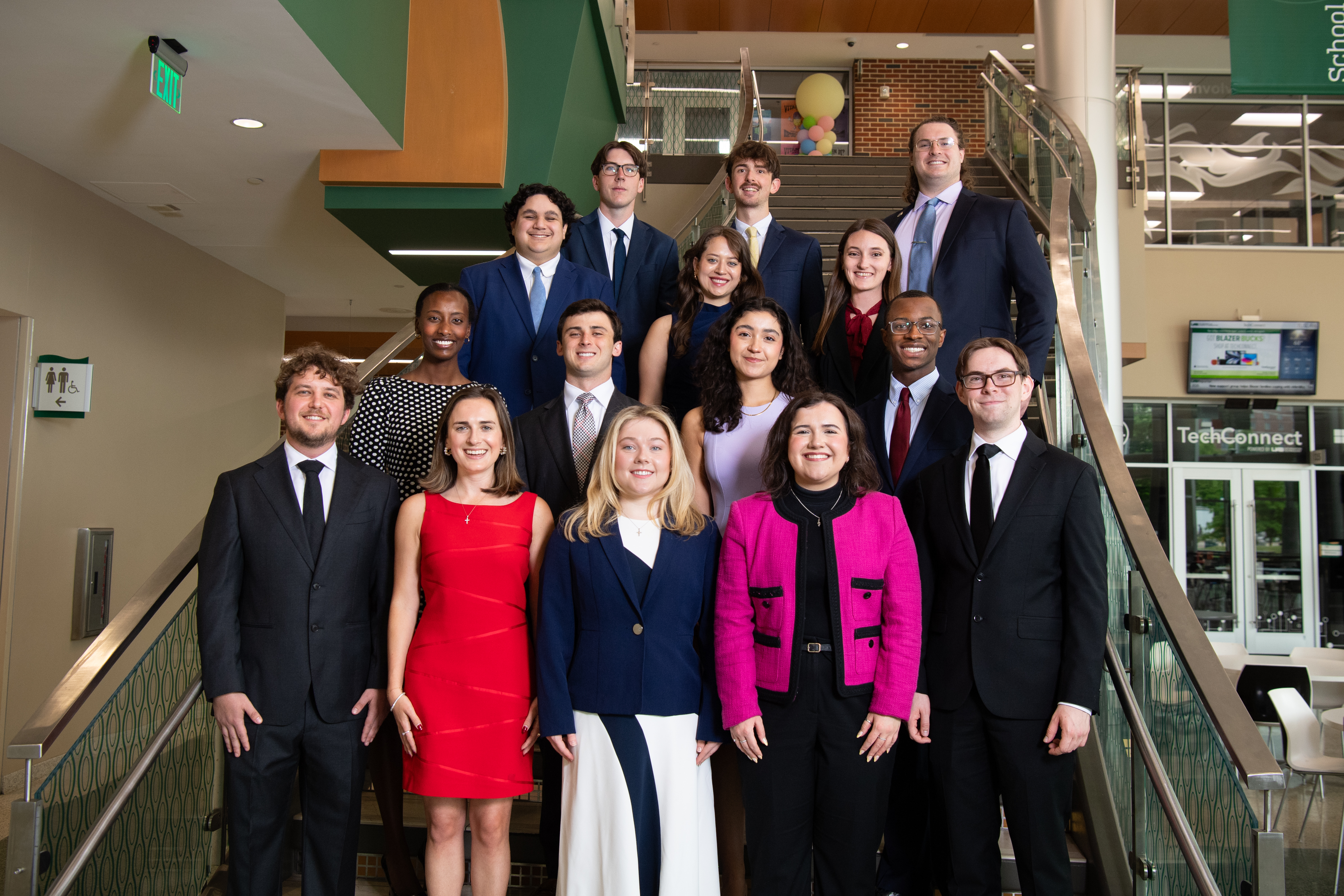 A group photo of the 2025 class of Capitol Scholars standing at the bottom of a stairs.